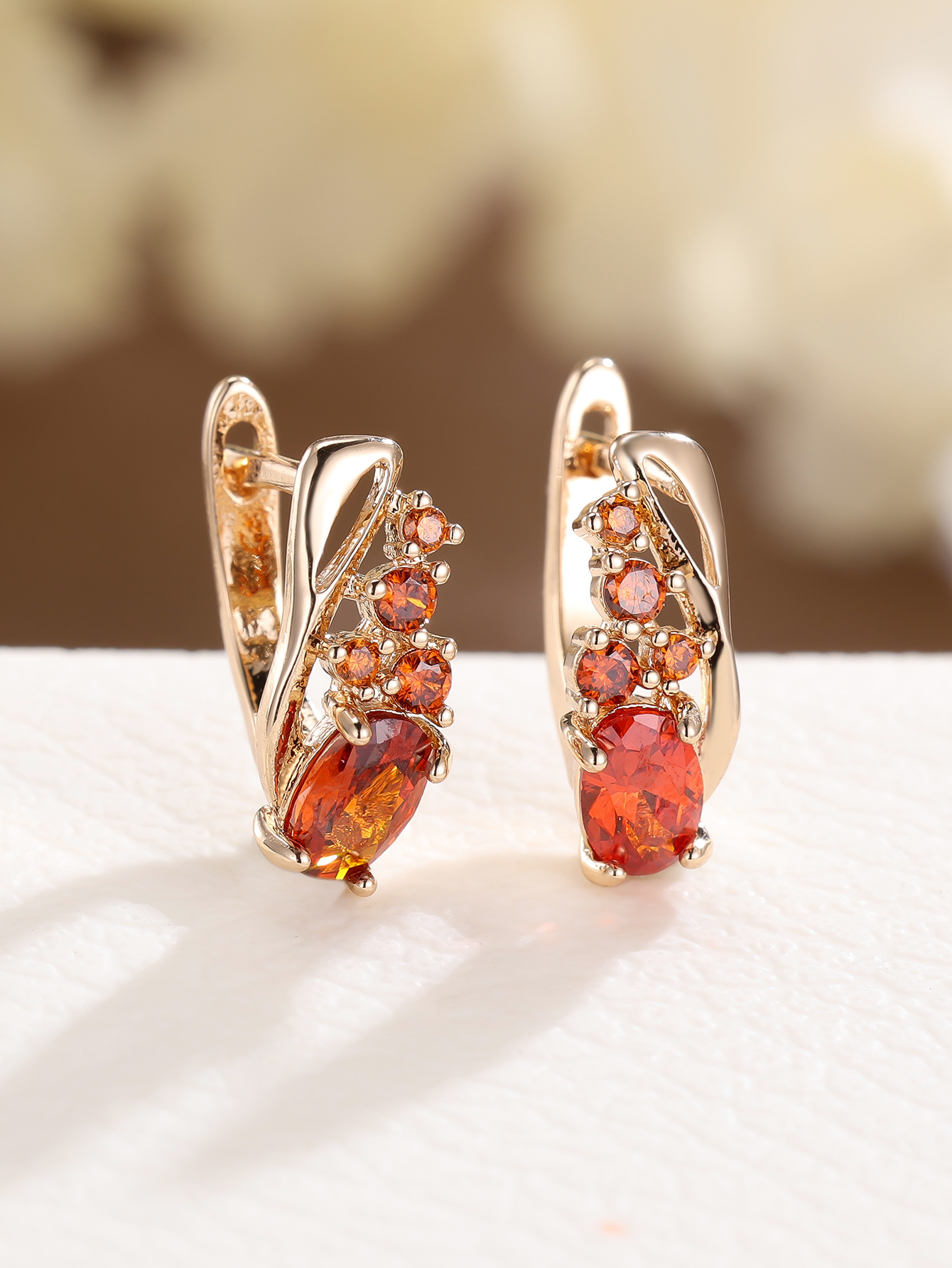 Champagne gold earrings with four small round diamonds and oval cubic zirconia stones - elegant, fashionable, and vintage style for women.