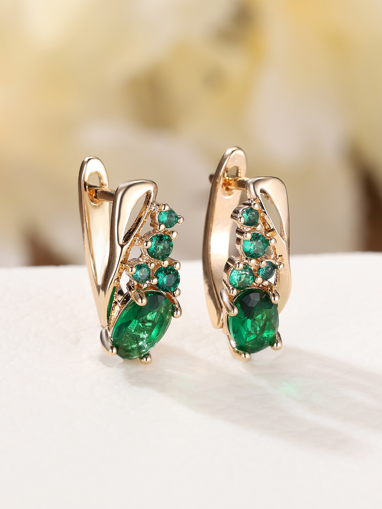 Champagne gold earrings with four small round diamonds and oval cubic zirconia stones - elegant, fashionable, and vintage style for women.