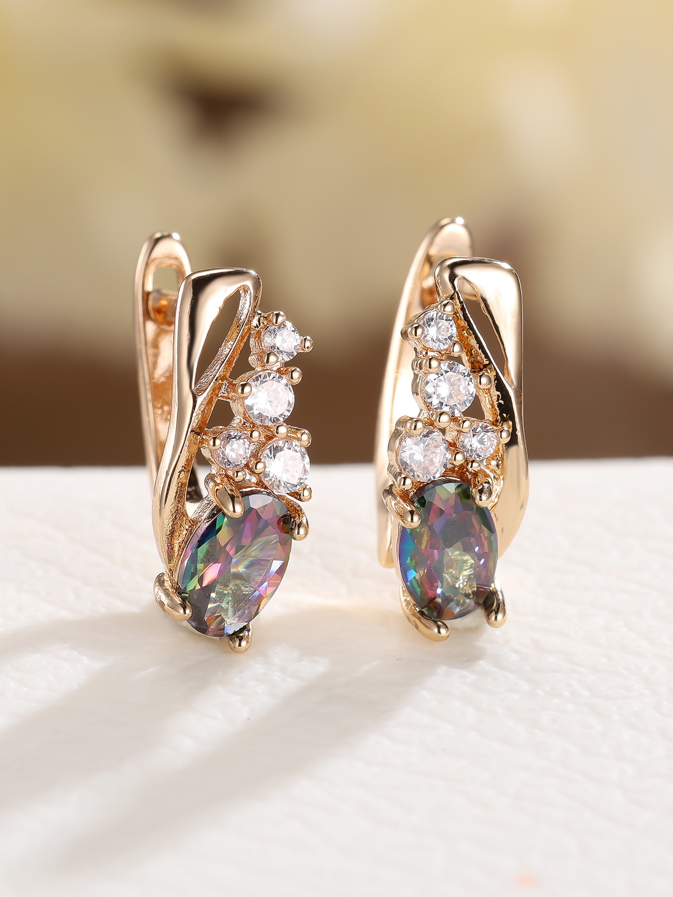 Champagne gold earrings with four small round diamonds and oval cubic zirconia stones - elegant, fashionable, and vintage style for women.