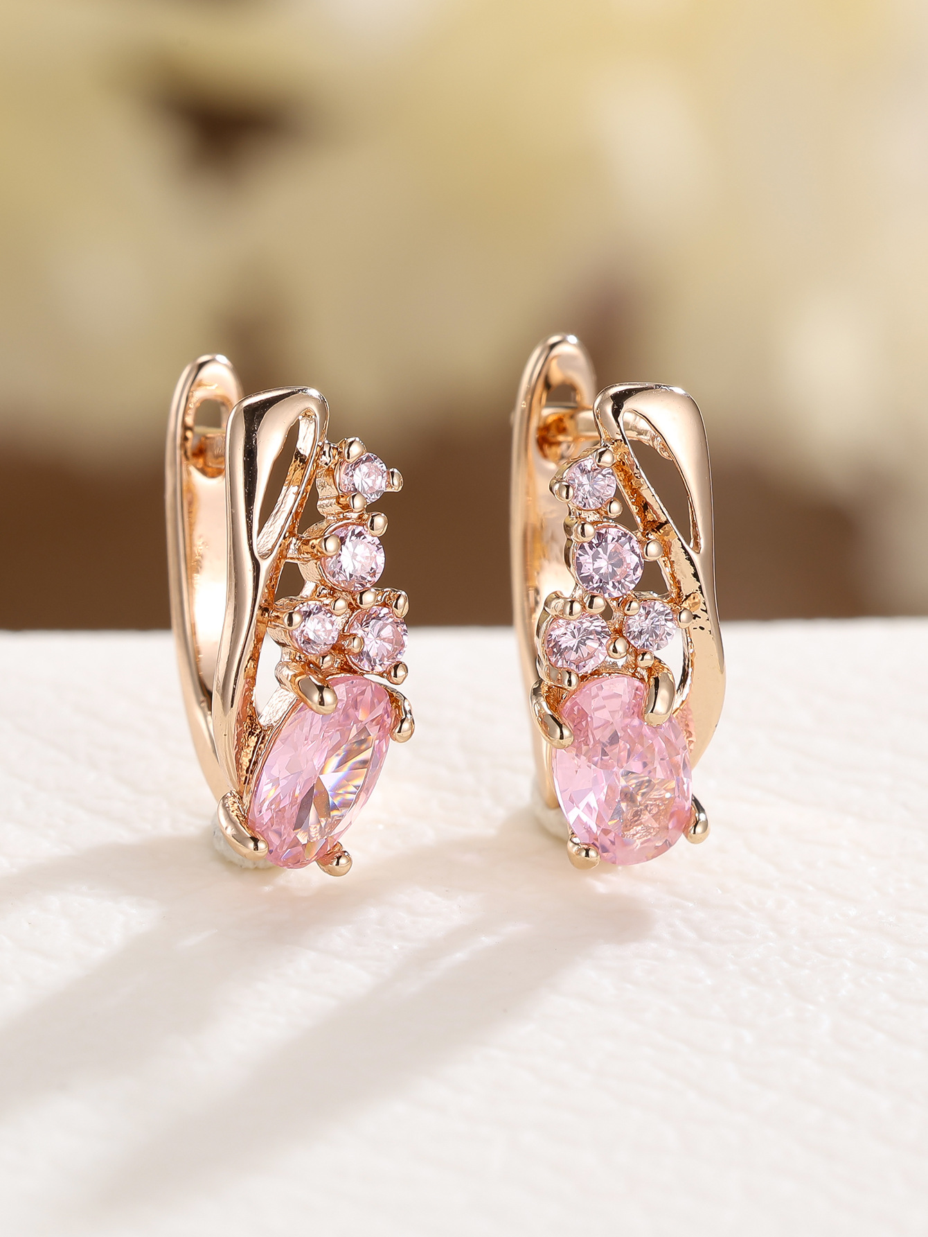 Champagne gold earrings with four small round diamonds and oval cubic zirconia stones - elegant, fashionable, and vintage style for women.