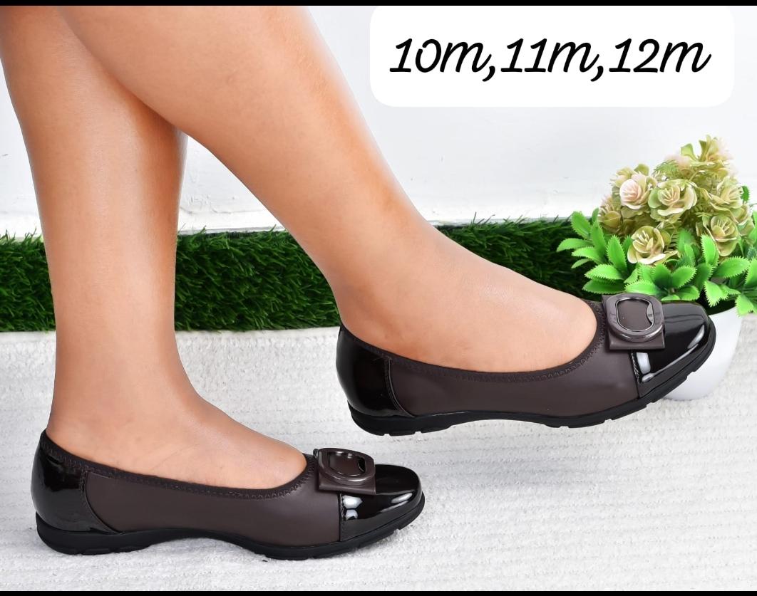 Comfortable Simple High Quality  flat shoes with black patent accents and a buckle detail.