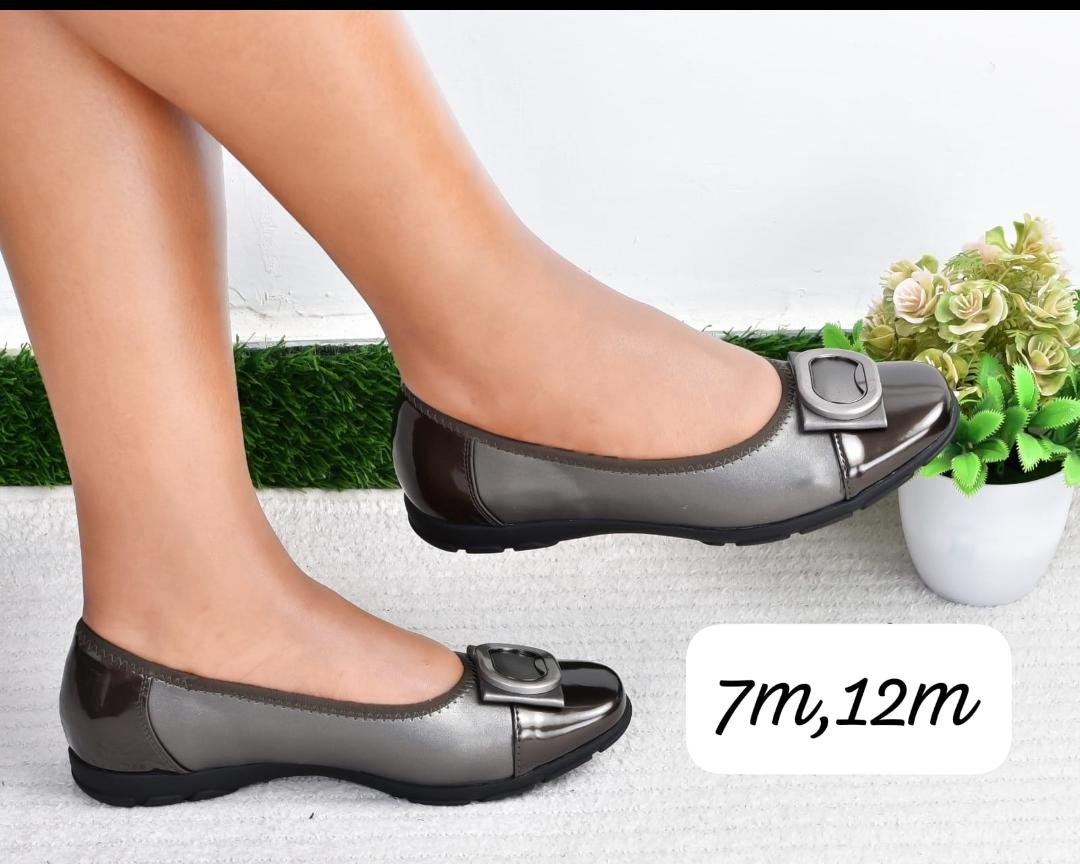 Comfortable Simple High Quality  flat shoes with black patent accents and a buckle detail.