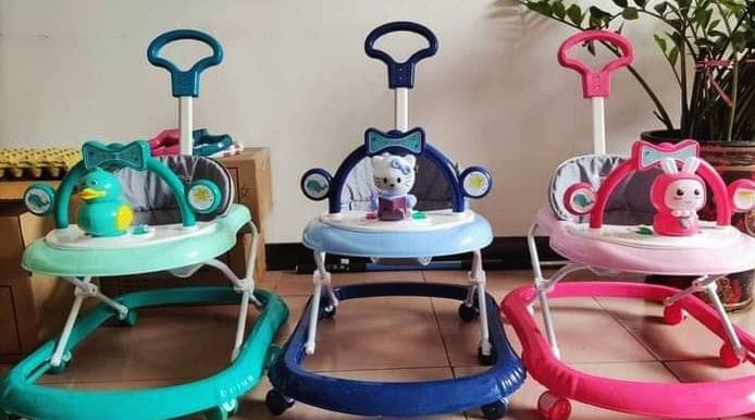 BABY WALKER. Mom Easy Baby Walker With Music, Toys And Push Handle, features a high back seat for added support, Battery operated, removable toy tray.