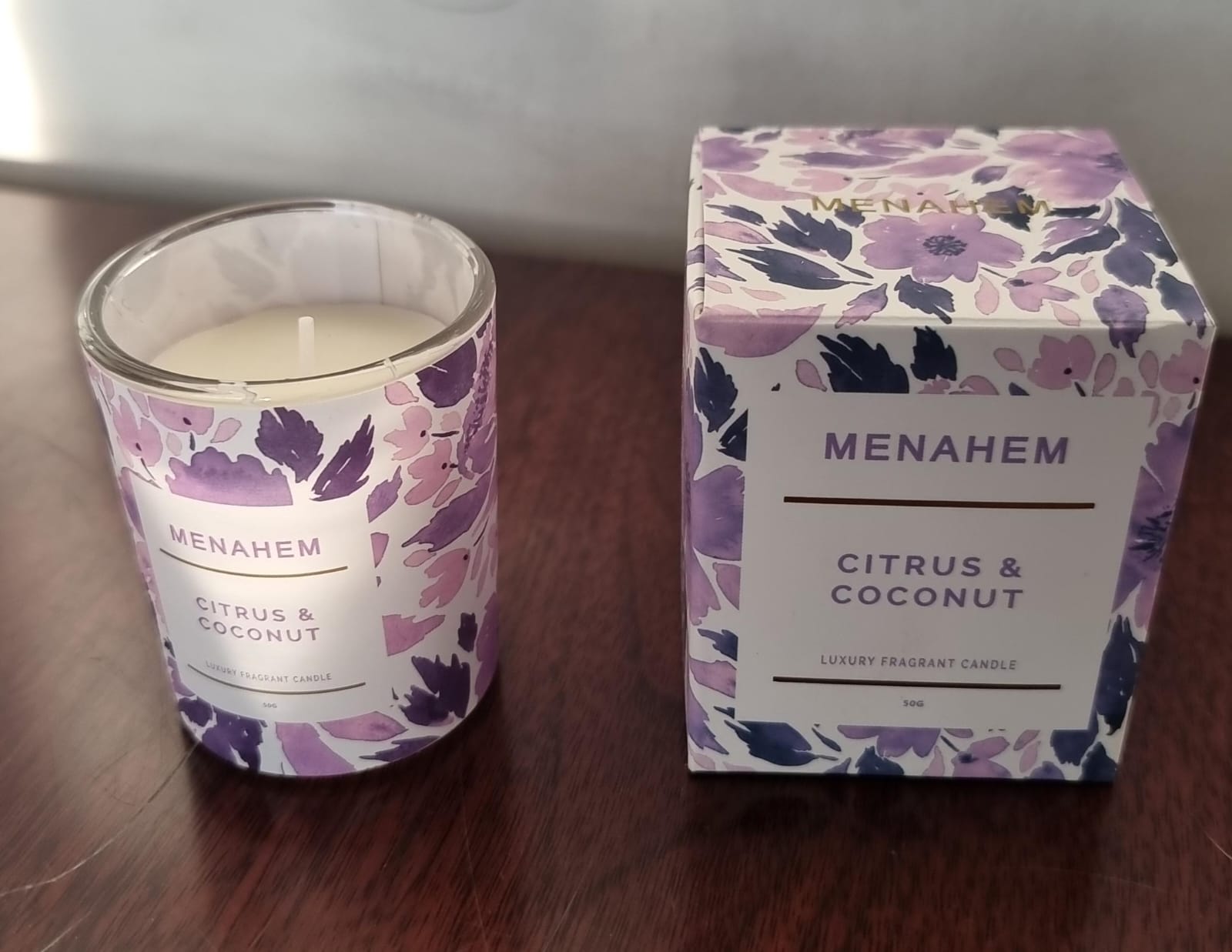 Menahem scented candle in elegant glass jar, long-lasting fragrance for home décor, relaxation and gifting. Clean burn, premium wax, stylish design perfect for bedrooms, living rooms