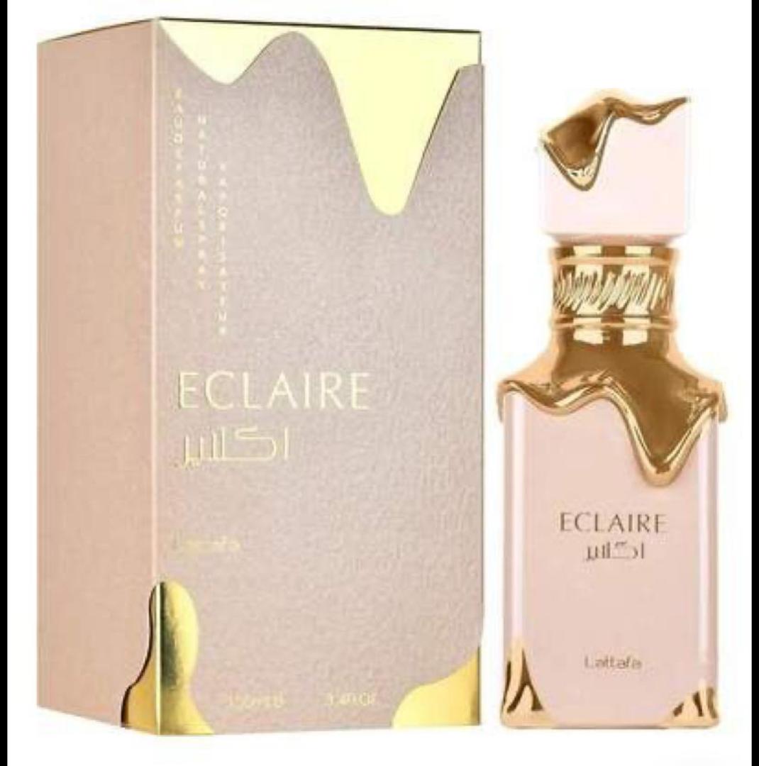 50 Ml Lattafa Eclaire Pink bottle with gold drip. Creamy gourmand scent of caramel, milk, honey, vanilla. Sweet, cozy, dessert-like.