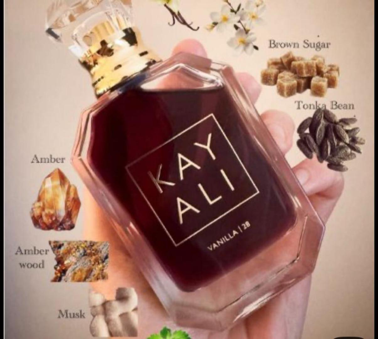 100Ml Kayali Vanilla | 28 perfume in a faceted glass bottle with gold accents and a crystal-like cap. Deep amber-red juice inside. The label shows "KAY ALI" in gold within a square frame.