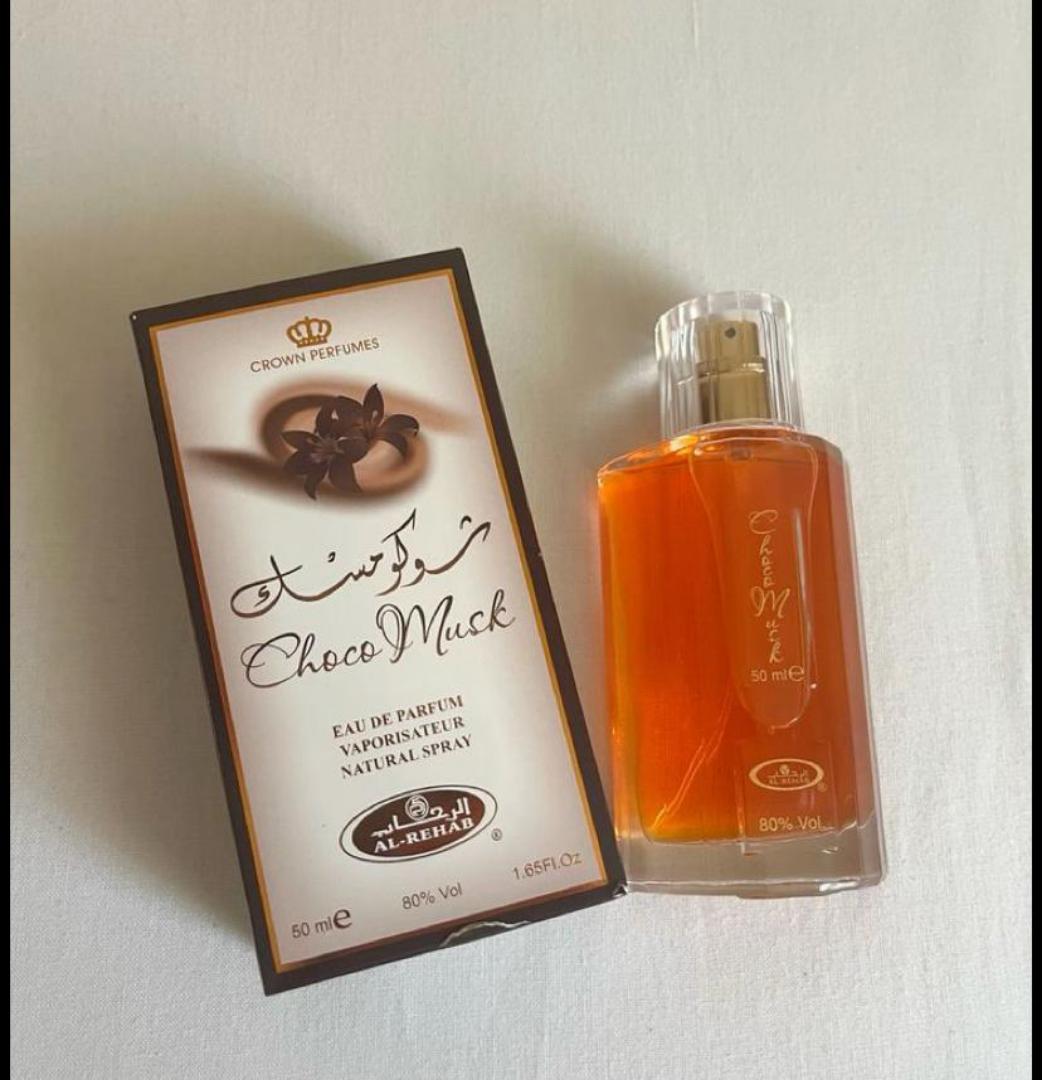 Choco Musk by Al-Rehab is a 50ml Eau de Parfum with a warm, sweet chocolate gourmand scent. The amber liquid in a clear glass bottle offers a cozy, indulgent aroma blending chocolate, vanilla, musk.