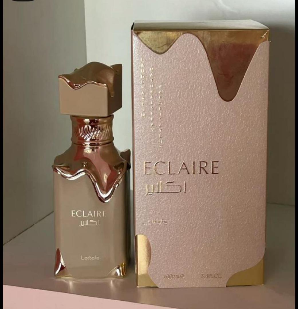 50 Ml Lattafa Eclaire Pink bottle with gold drip. Creamy gourmand scent of caramel, milk, honey, vanilla. Sweet, cozy, dessert-like.