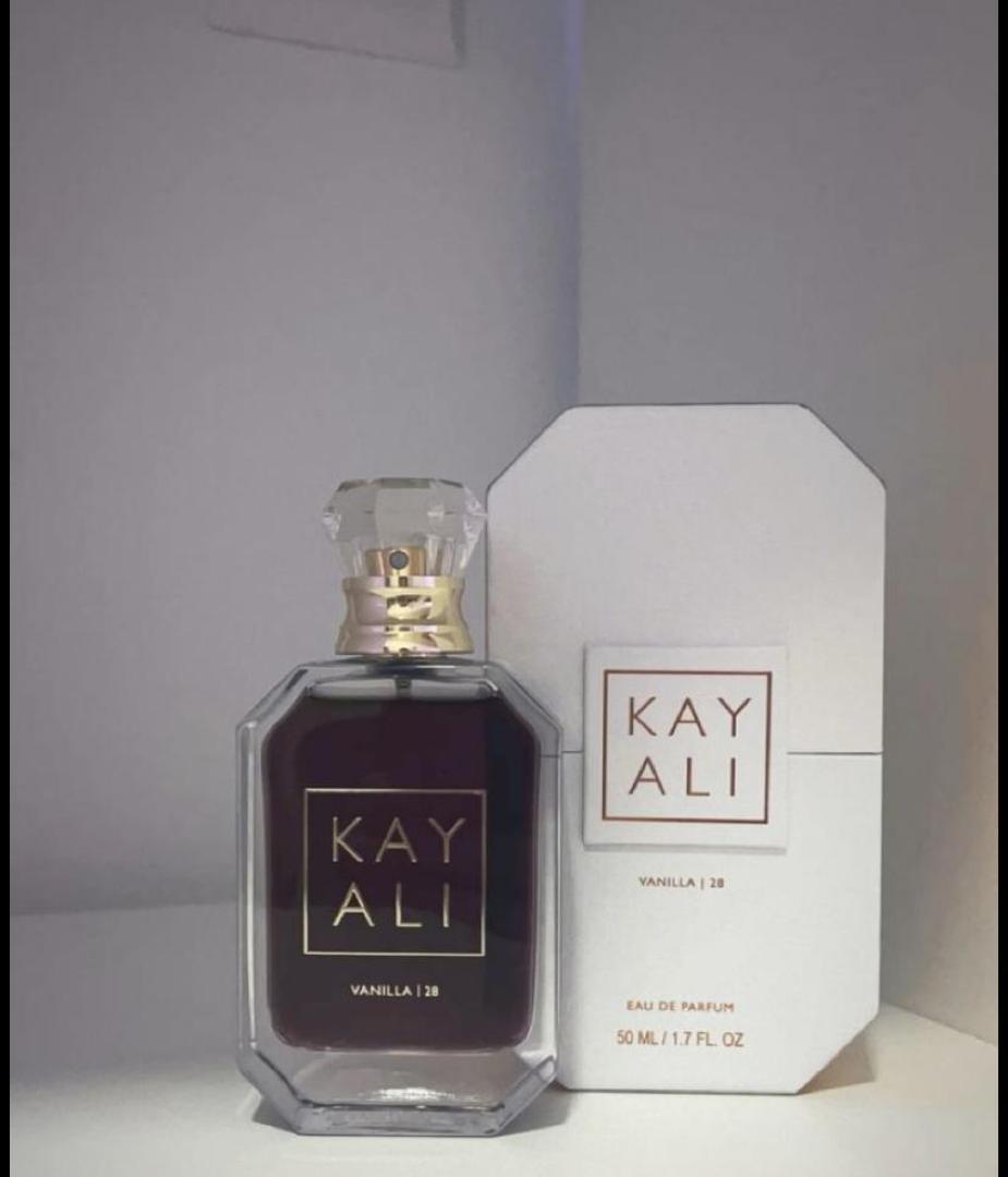 100Ml Kayali Vanilla | 28 perfume in a faceted glass bottle with gold accents and a crystal-like cap. Deep amber-red juice inside. The label shows "KAY ALI" in gold within a square frame.