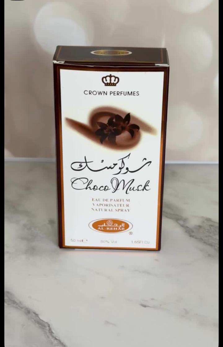 Choco Musk by Al-Rehab is a 50ml Eau de Parfum with a warm, sweet chocolate gourmand scent. The amber liquid in a clear glass bottle offers a cozy, indulgent aroma blending chocolate, vanilla, musk.