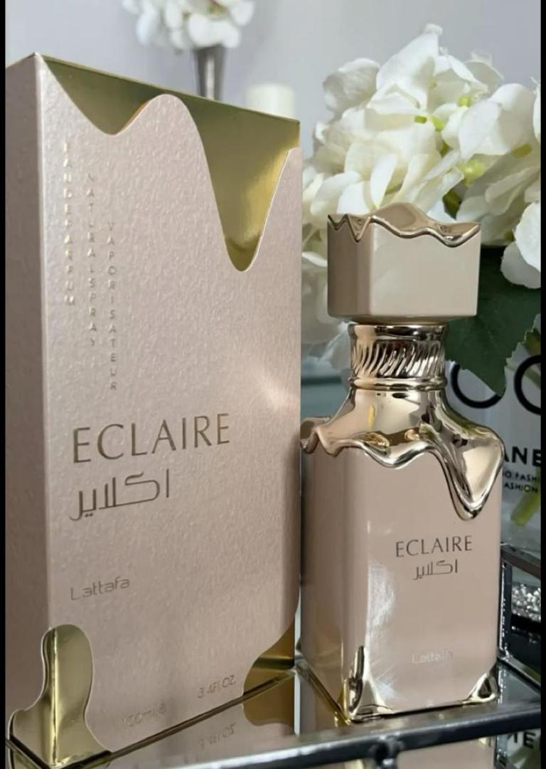 50 Ml Lattafa Eclaire Pink bottle with gold drip. Creamy gourmand scent of caramel, milk, honey, vanilla. Sweet, cozy, dessert-like.