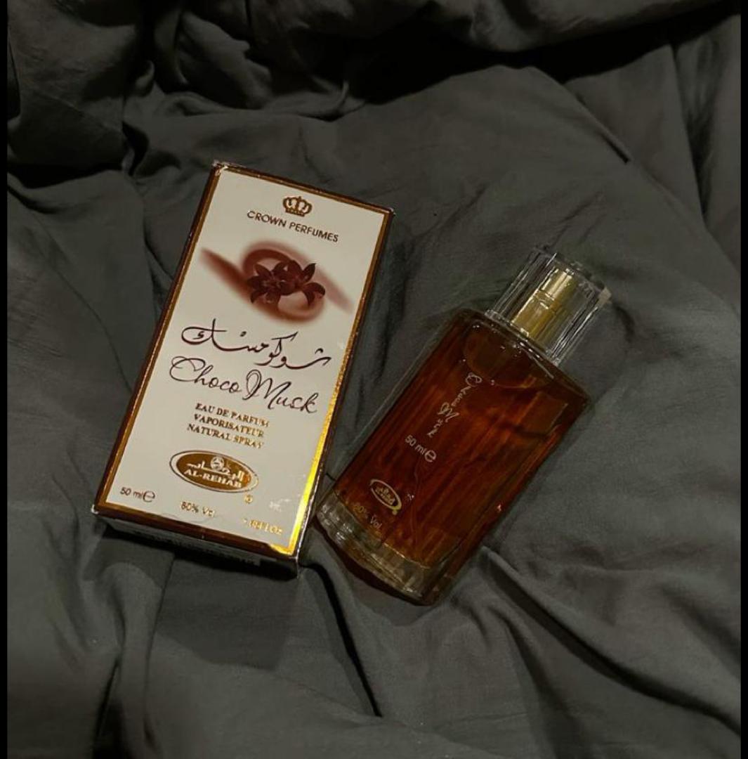 Choco Musk by Al-Rehab is a 50ml Eau de Parfum with a warm, sweet chocolate gourmand scent. The amber liquid in a clear glass bottle offers a cozy, indulgent aroma blending chocolate, vanilla, musk.