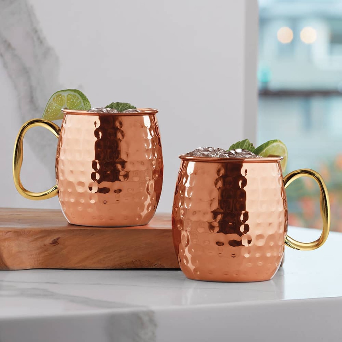 copper Moscow Mule mugs featuring brass handles and a polished finish mugs are traditionally used for serving Moscow Mules because the copper helps keep the drink chilled to enhance flavour .