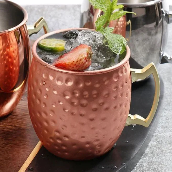 copper Moscow Mule mugs featuring brass handles and a polished finish mugs are traditionally used for serving Moscow Mules because the copper helps keep the drink chilled to enhance flavour .
